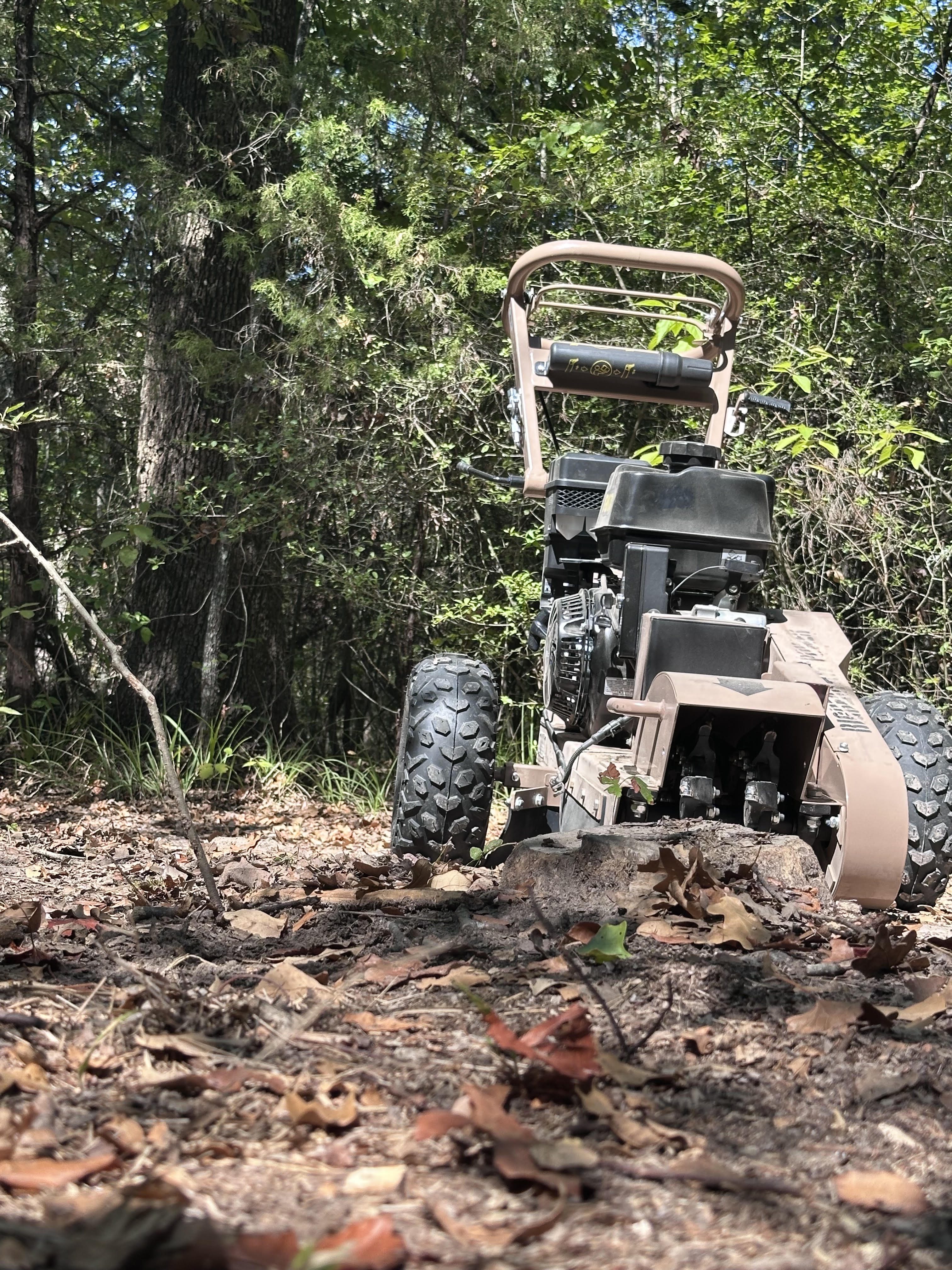 15HP stump grinder actively removing a tree stump — equipment rental in Kemp TX
